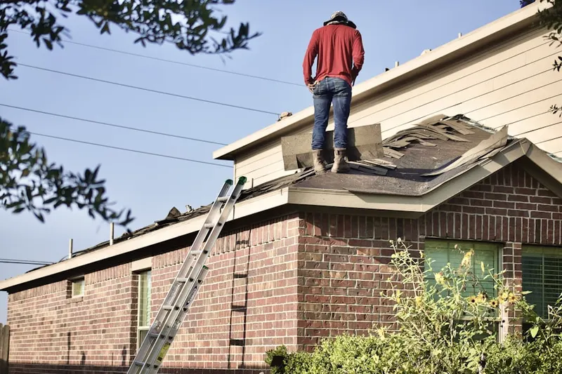 Professional roofer working on a residential roof in Wolf Ranch